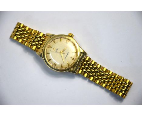 A gentleman's 14k gold Omega Automatic Seamaster wristwatch with 17-jewel movement no.14139619, gilt-mounted cream dial, on g