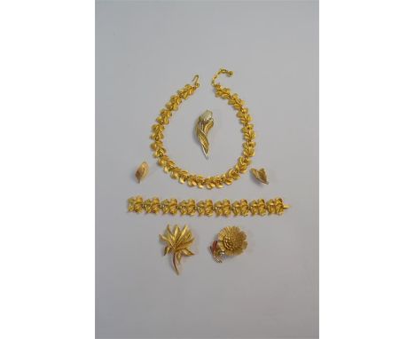 Trifari - Six items of vintage gilt-metal costume jewellery including matching necklace and bracelet, three spray brooches an