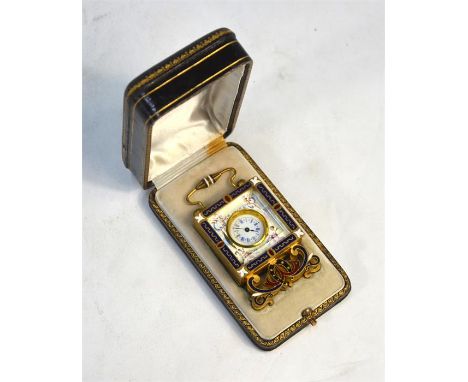An early 20th century Continental small gilt metal and enamel strut-clock with bevelled glass over enamel dial within surroun