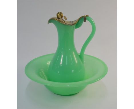 A 19th century opaque green glass wash basin, 37 cm diam. to/w a matching water jug having a brass cover with apple &amp; lea