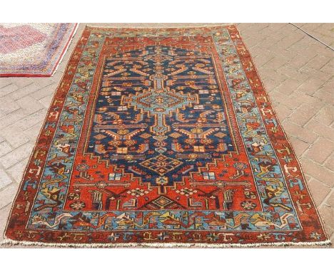 A Persian Malayer rug, light blue central medallion on navy ground with floral motiff within bouble border, 195 x 135 cm