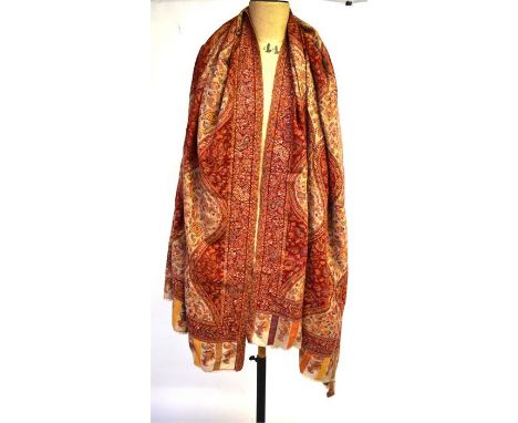 A large heavy-weight hand-worked Kashmir shawl with paisley floral and foliate design in red/peach and ecru hues, and a large