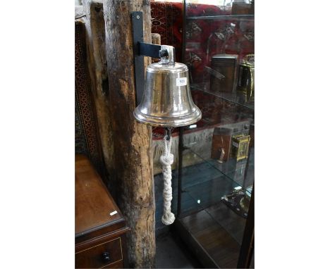 A vintage heavy cast brass fire station bell with rope pull, &nbsp;21 cm dia., mounted to a wall bracket