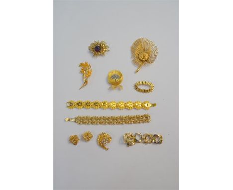 A collection of vintage gilt metal costume jewellery including a large spray brooch stamped Monet, three bracelets, pair of c