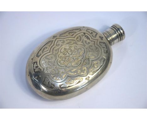 A Victorian oval silver hip-flask with screw cover, chased with Gothic foliage and strapwork, Thomas Johnson I, London 1875, 