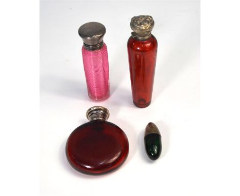 A Victorian ridged cranberry glass smelling salts bottle with silver top, Birmingham 1894, to/w two ruby glass examples with 