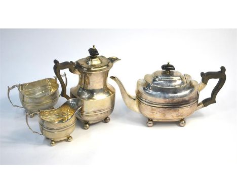 An Edwardian silver three piece tea service in the Georgian manner, of oblong form on ball feet, Thomas Bradbury &amp; Son, L