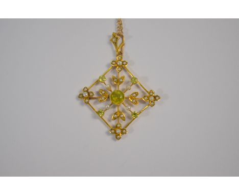 An Art Nouveau pendant set with peridot and seed pearls on yellow metal wirework trellis on seed pearl set hanger, stamped 9c
