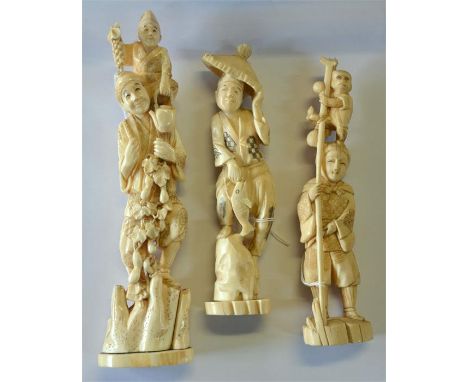 A Japanese stained ivory okimono of a standing Sarumawashi with a monkey standing on his head, 23 cm high; together with a si