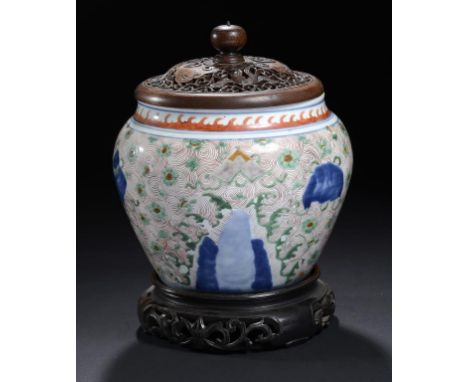 A CHINESE WUCAI JAR, TRANSITIONAL painted with precious objects on blue peaks and a sea of iron red waves, 17cm h, wood stand