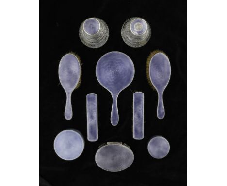 A GEORGE V SILVER AND MAUVE GUILLOCHE ENAMEL BRUSH SET  to include a graduated pair of round boxes and covers and an oval jew