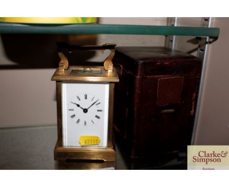 A brass cased carriage clock AF; and a leather carriage clock case