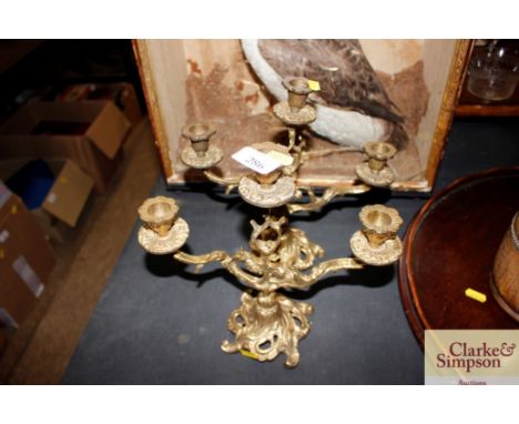 A pair of ornate brass three light candelabra