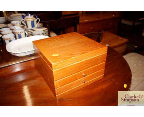 A modern light wood jewellery cabinet 