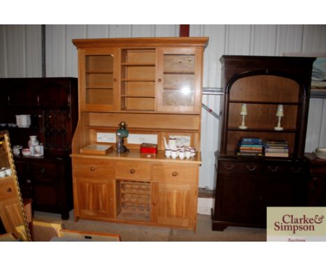 A large light wood kitchen dresser with glazed top