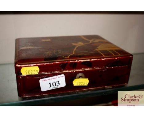 A lacquered trinket box and contents of miniature porcelain items 