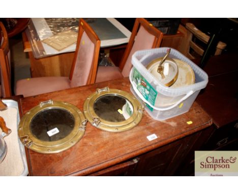 A pair of brass porthole mirrors; and a pendant light fitting with glass drops 