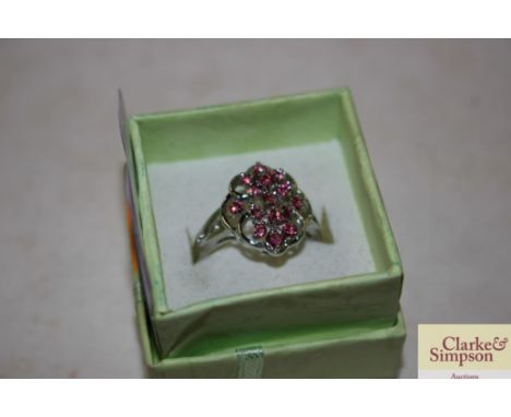 A white metal and pink stone set dress ring 