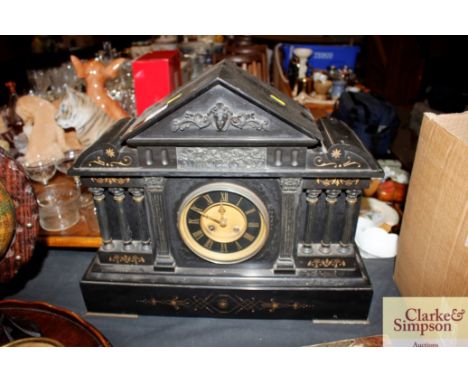 A Victorian black slate mantel clock in architectural design case 