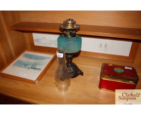 An early 20th Century table oil lamp on cast iron base