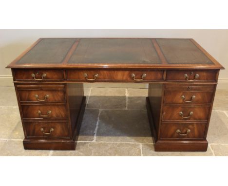 A George III style mahogany twin pedestal desk, late 20th century, by Reprodux, the rectangular moulded top with triptych ins