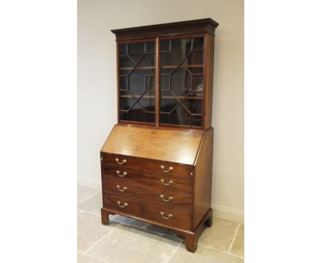 A 19th century mahogany bureau bookcase, the dentil cornice above a pair of astragal glazed doors enclosing two adjustable sh