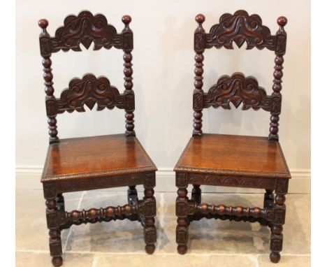 A pair of 17th century style oak Derbyshire side chairs, 20th century, each with a carved rung back above a board seat, raise