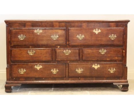 A George III oak and mahogany cross banded dresser base, possibly converted from a Lancashire mule chest, the rectangular mou