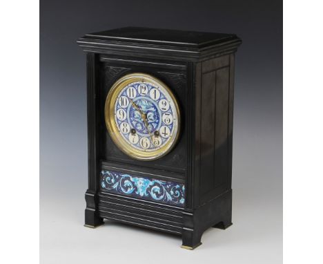 A late 19th century Aesthetic movement slate mantel clock, the rectangular case with incised spandrels enclosing the 13cm ena