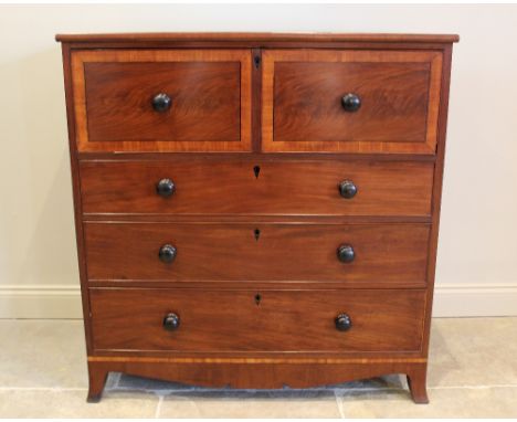 An early 19th century mahogany and satinwood cross banded secretaire chest of drawers, the fall front top drawer opening to a