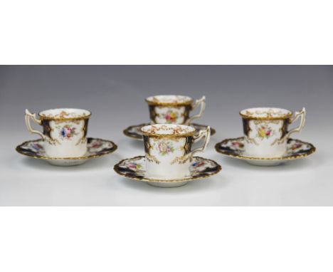 Four Coalport 'batwing' coffee cups and saucer, early 20th century, each piece decorated with gilt scrolls enclosing floral s