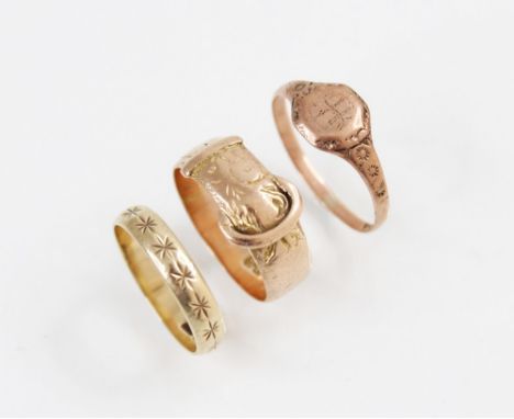 A 9ct gold buckle ring, marks for Birmingham 1918, ring size M, together with a 9ct gold signet ring, ring size P, and a 9ct 