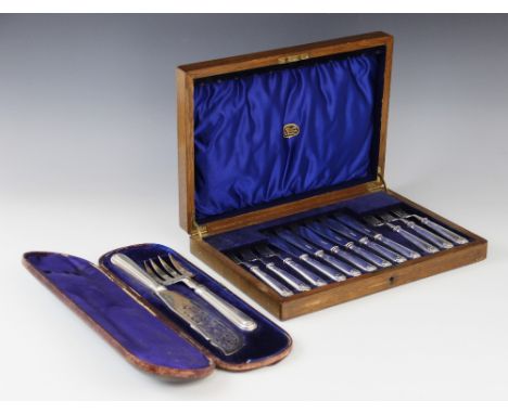 A set of six George V silver fish knives and forks by Thomas Bradbury & Sons Ltd, Sheffield 1919, each weighted handle with s