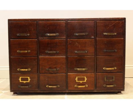 A George V oak filing cabinet, with an arrangement of sixteen small drawers, raised upon later feet, 68cm H x 102cm W x 53cm 