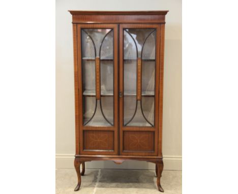 An Edwardian inlaid mahogany display cabinet, the pair of glazed doors centred with a panel inlaid with graduated hare bells,