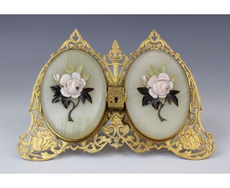 A gilt brass twin portrait picture frame, 19th century, the pierced twin arched easel frame supporting hinged onyx doors, eac