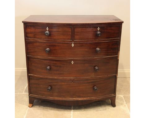 An early 19th century mahogany bow front chest of drawers, with an arrangement of two short over three long graduated and coc