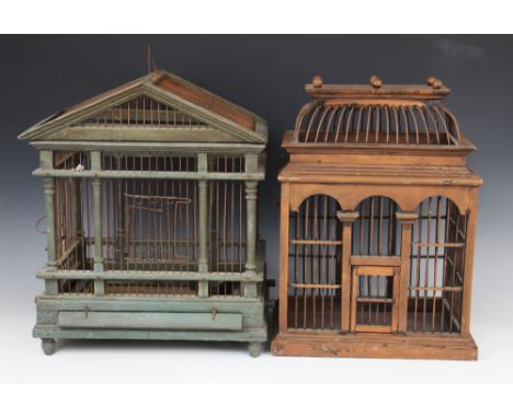 A painted wood and wire work architectural bird cage, 20th century, the triangular gable and twin rail portico raised upon ri