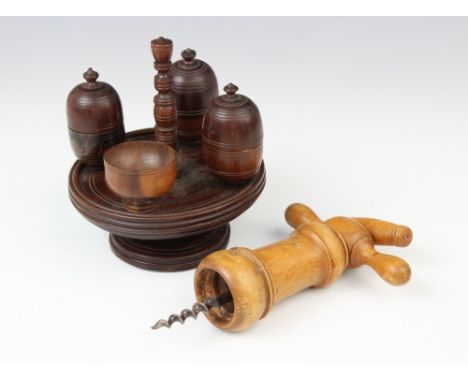 A ring turned walnut cruet set, 19th century, the footed stand with turned bobbin handle and four fixed turned cups, with thr