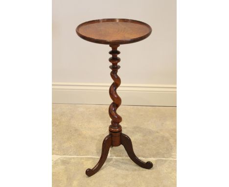 A George III and later mahogany wine table, the circular mahogany tray top raised upon an associated&nbsp; barley twist colum