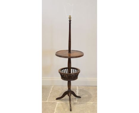 An early 20th century stained beech wood standard lamp and dumb waiter combined, the top circular moulded tray above a galler