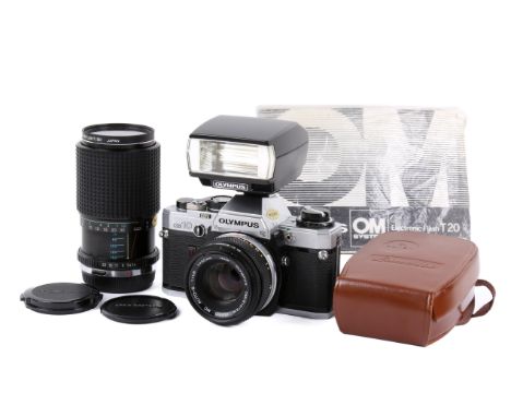 An Olympus OM10 35mm SLR camera outfit. Chrome body. Serial number 1003835. With two lenses; an Olympus OM 50mm f1.8 Zuiko MC