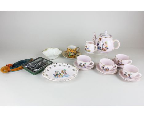 A child's tea set including teapot, milk jug, four cups and saucers and a dish, together with miniature knives and spoons and