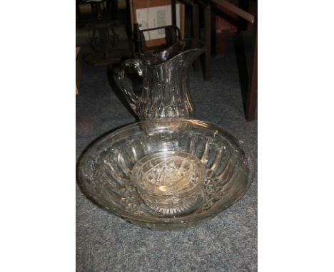 A moulded glass jug, basin, soap dish and dish and cover
