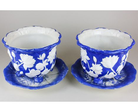 A pair of Minton pottery blue and white planters with floral detail, both with leaf shaped saucers, 20cm diameter