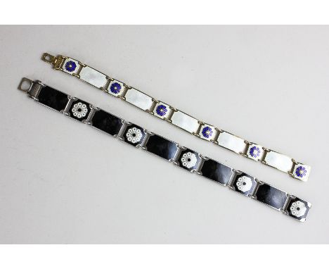 David Andersen, a silver and white enamel bracelet with blue floral panels and a black enamel bracelet with white floral deta