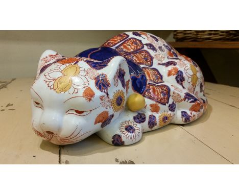 A large 20th Century Chinese ceramic enlightened lucky cat, decorated in a pattern of lotus and peony blossom, coins and othe