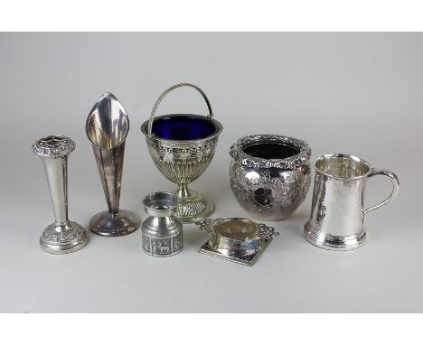 A silver plated sugar bowl with blue glass liner, two bud vases, a tankard, a strainer, a vase and a pewter stand