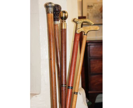 A George V silver topped cane with scroll decoration, together with four other canes and a blue and white Chinese stick stand