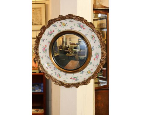 A Clarice Cliff pottery edged mirror with gilt border marked Art Master Products, 48cm diameter